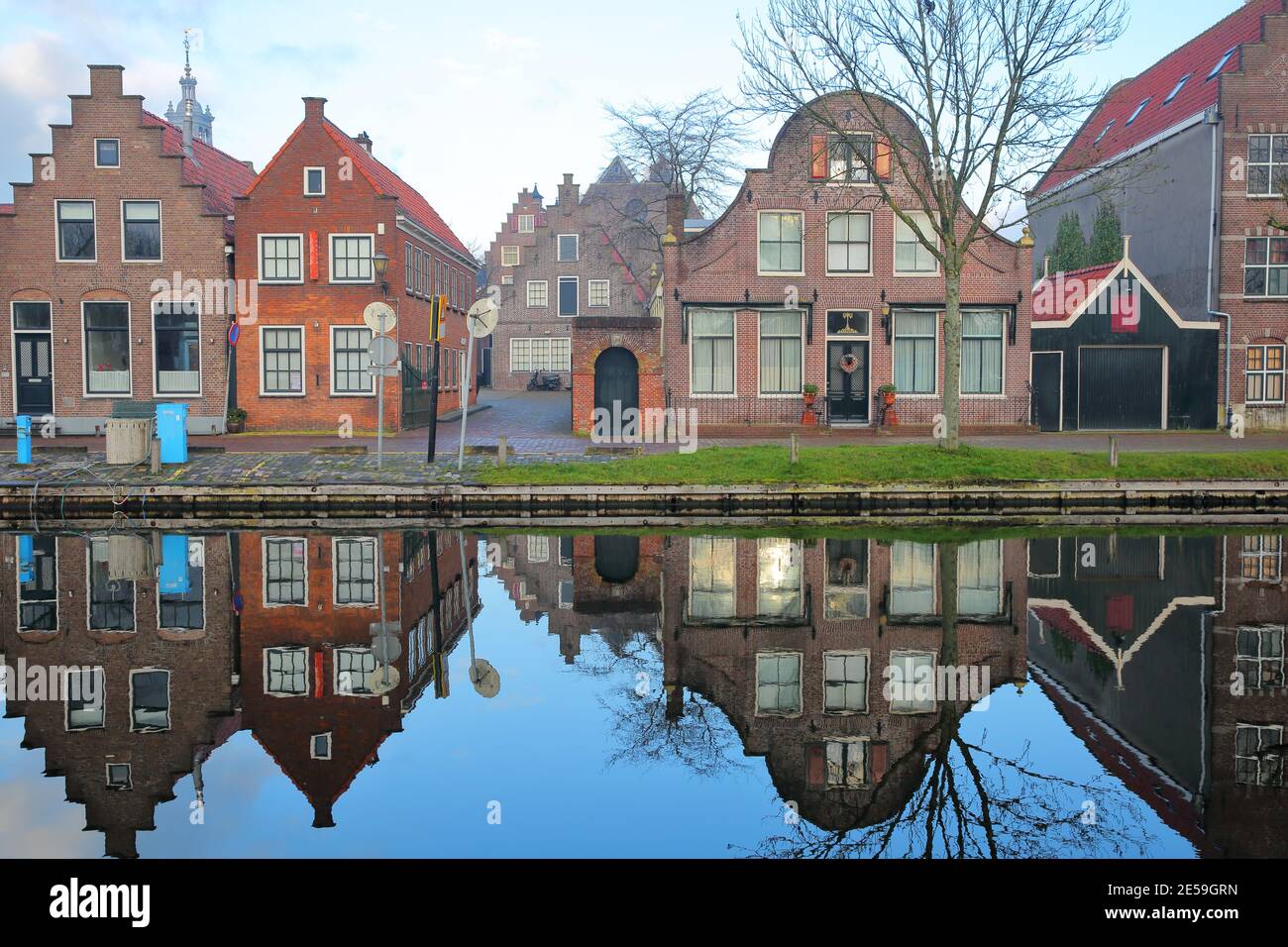 Reflections of historic and colorful houses along Nieuwe Haven street