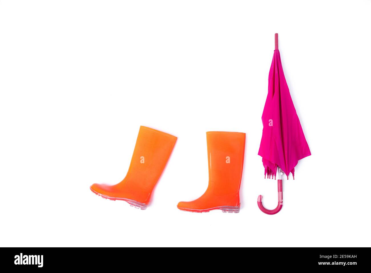 Rubber shoes and umbrella isolated on white background. Rain season and
