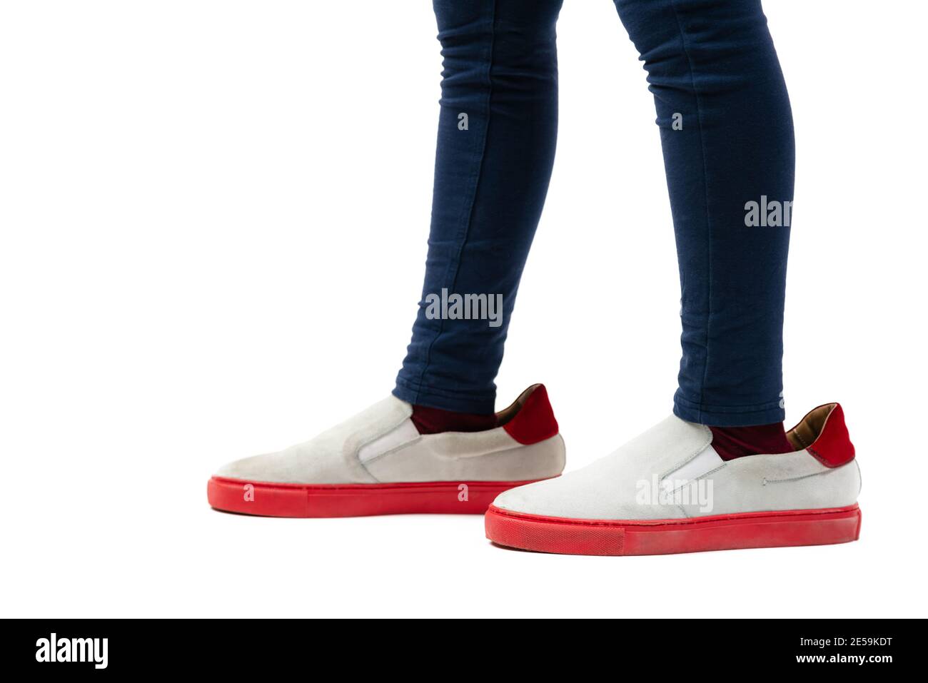 Closeup of kid wearing adult shoes on white background. Concept of maturity and growing up. Stock Photo