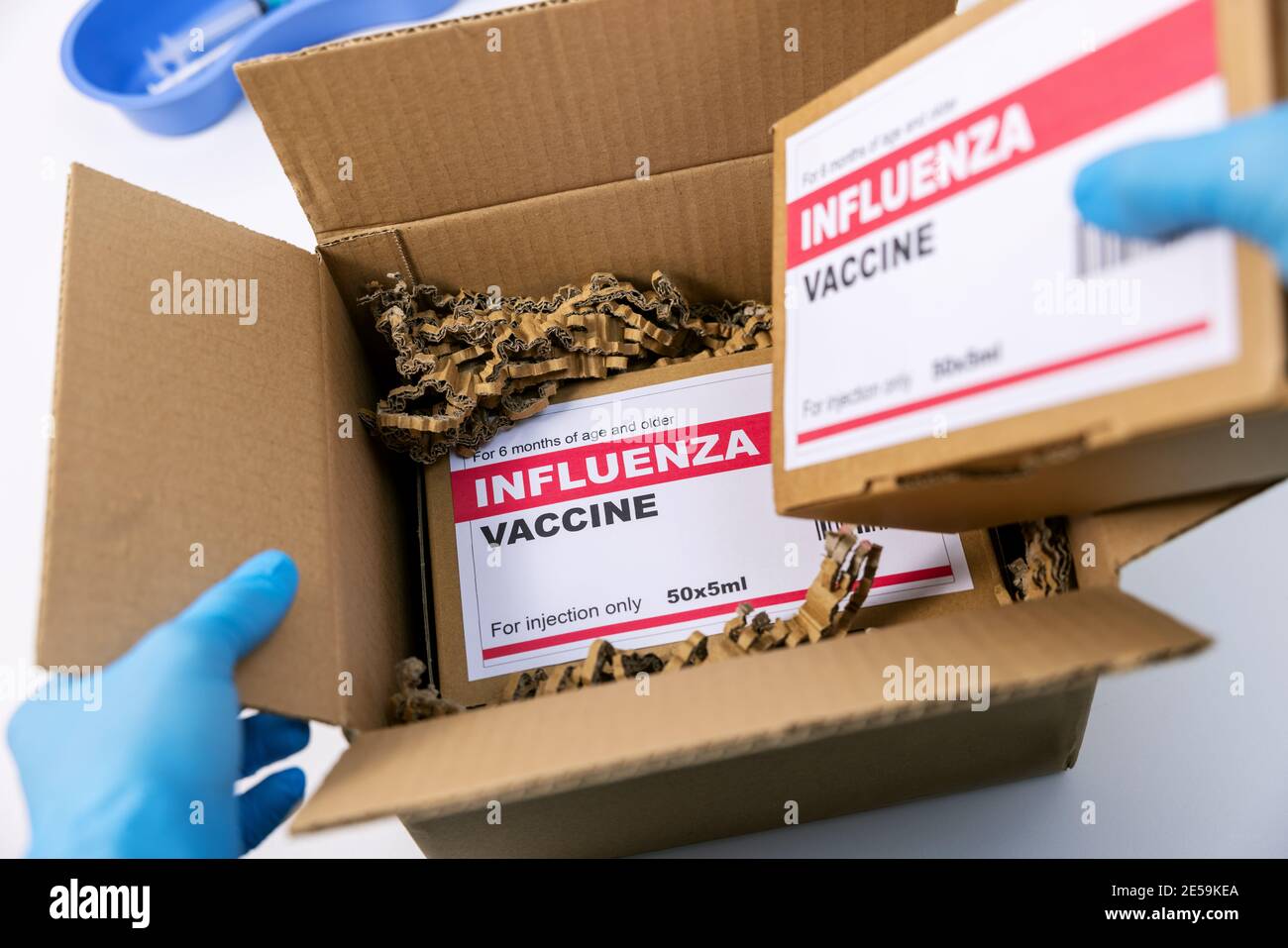 medical products distribution and shipping. opened box with flu vaccine packages Stock Photo