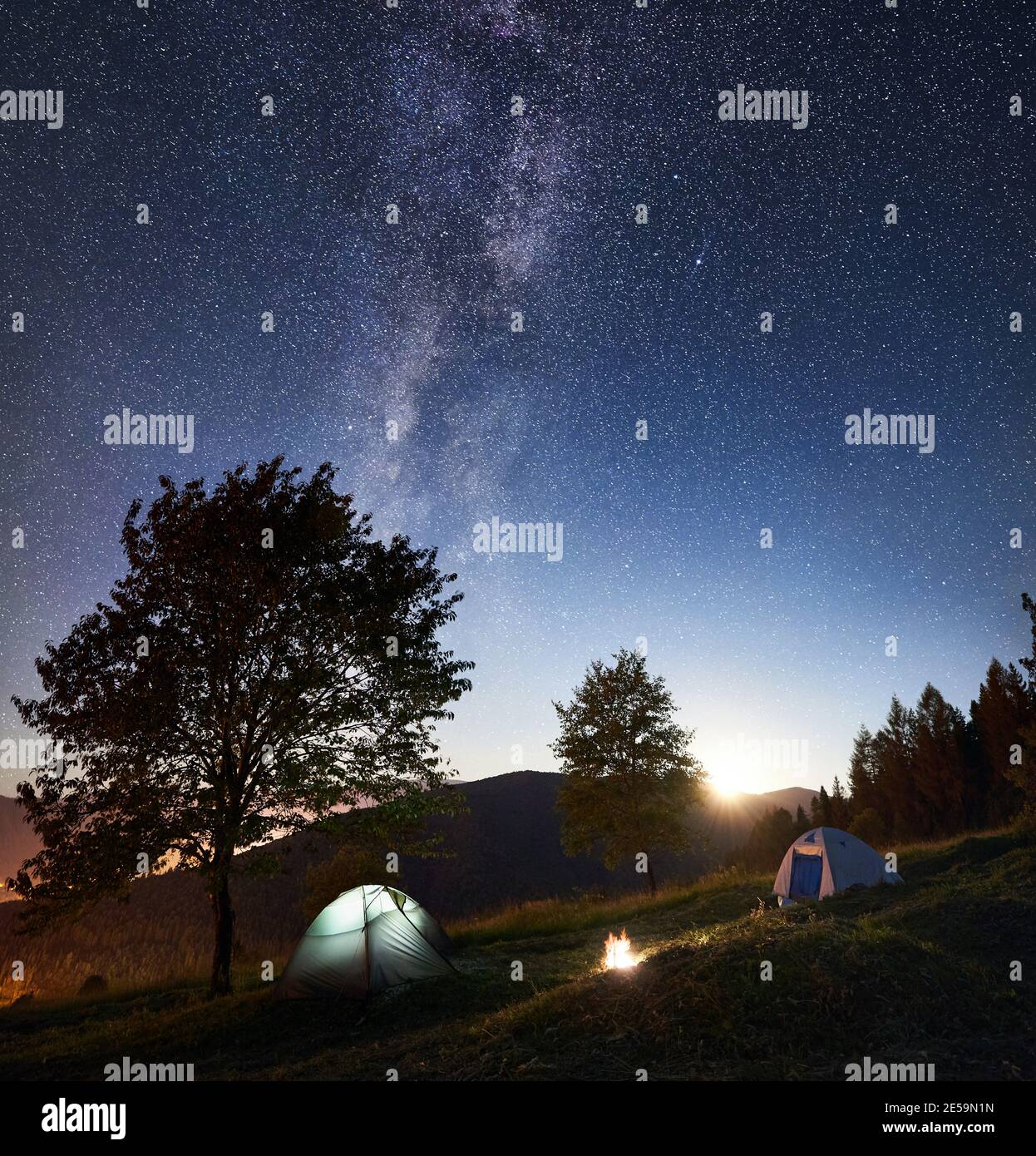 Tourist Camping Near Forest At Night Two Glowing Tents And Bonfire Under Amazing Night Sky Full Of Stars And Milky Way On The Background Trees Beautiful Starry Sky Mountains And Full Moon Tourist Camping Near Forest At Night Two Glowing Tents And Bonfire Under Amazing Night Sky Full Of Stars And Milky Way On The Background Trees Beautiful Starry Sky Mountains And Full Moon