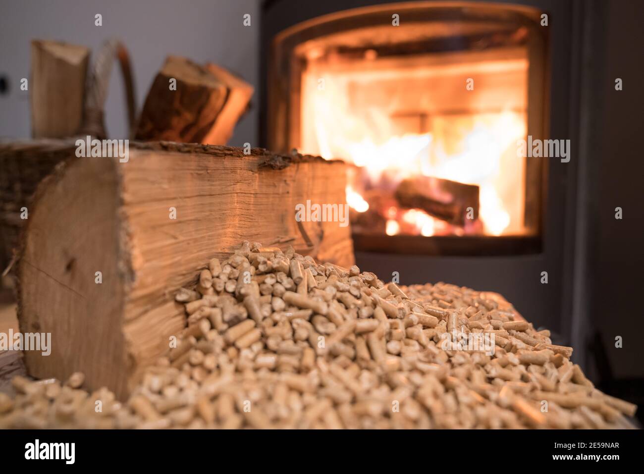 Wood stove heating with in foreground wood pellets - economical heating system concept Stock Photo