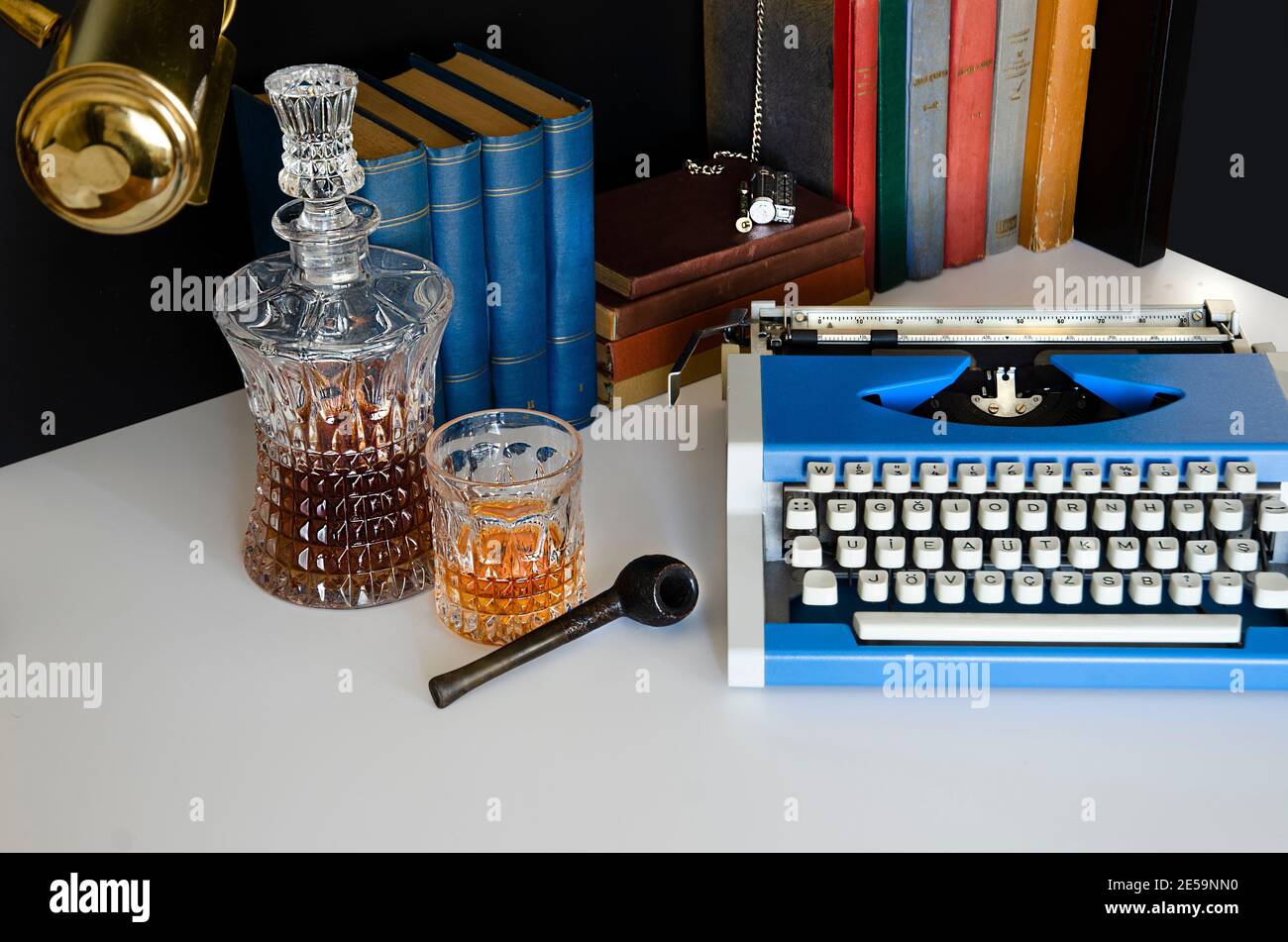Books, literature, knowledge library, lighter, flint, smoking pipe and old clock. Sherlock Holmes Office Desk Stock Photo