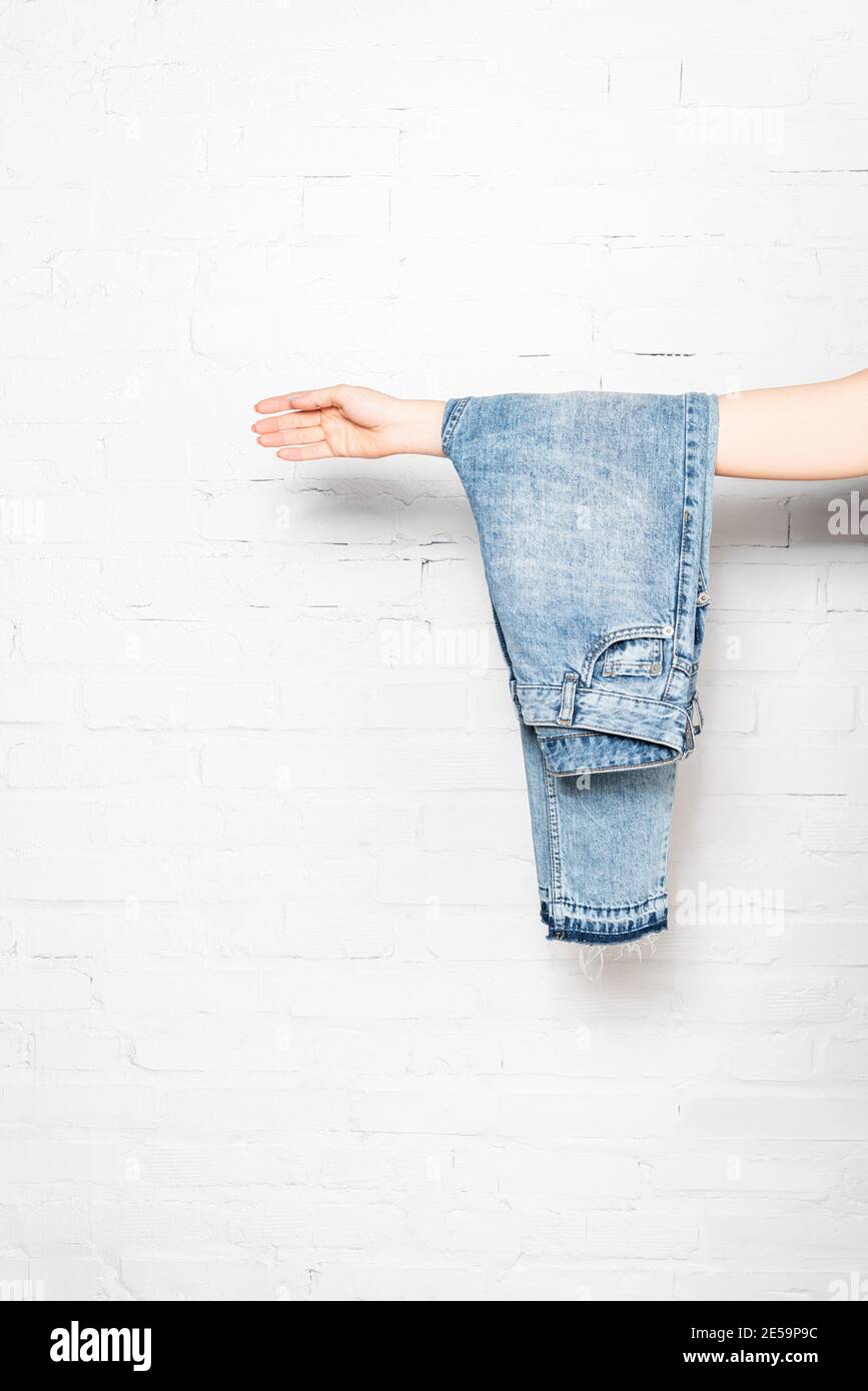 Man´s pants and sweater hanging on hooks on the back of his bedroom door  Stock Photo - Alamy