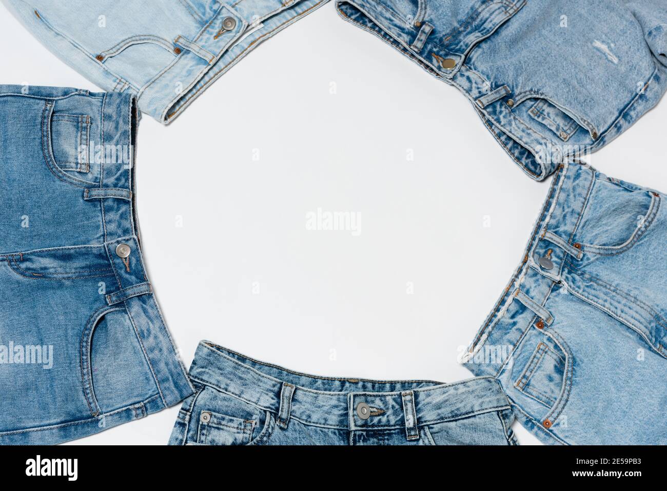 empty frame made from various blue jeans on white background, top view Stock Photo