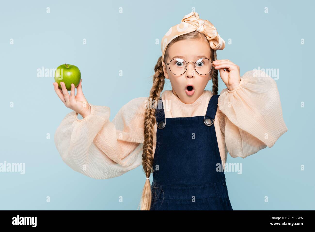 Premium Photo  Surprised kid holding huge apple anti stress