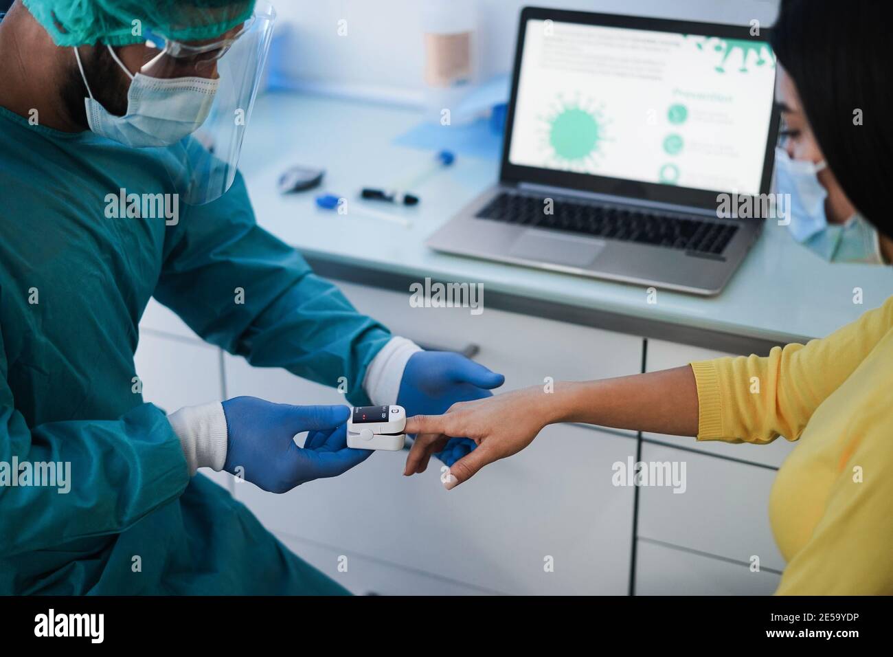 Doctor examining patient with fingertip pulse oximeter during coronavirus outbreak - Focus on girl hand Stock Photo