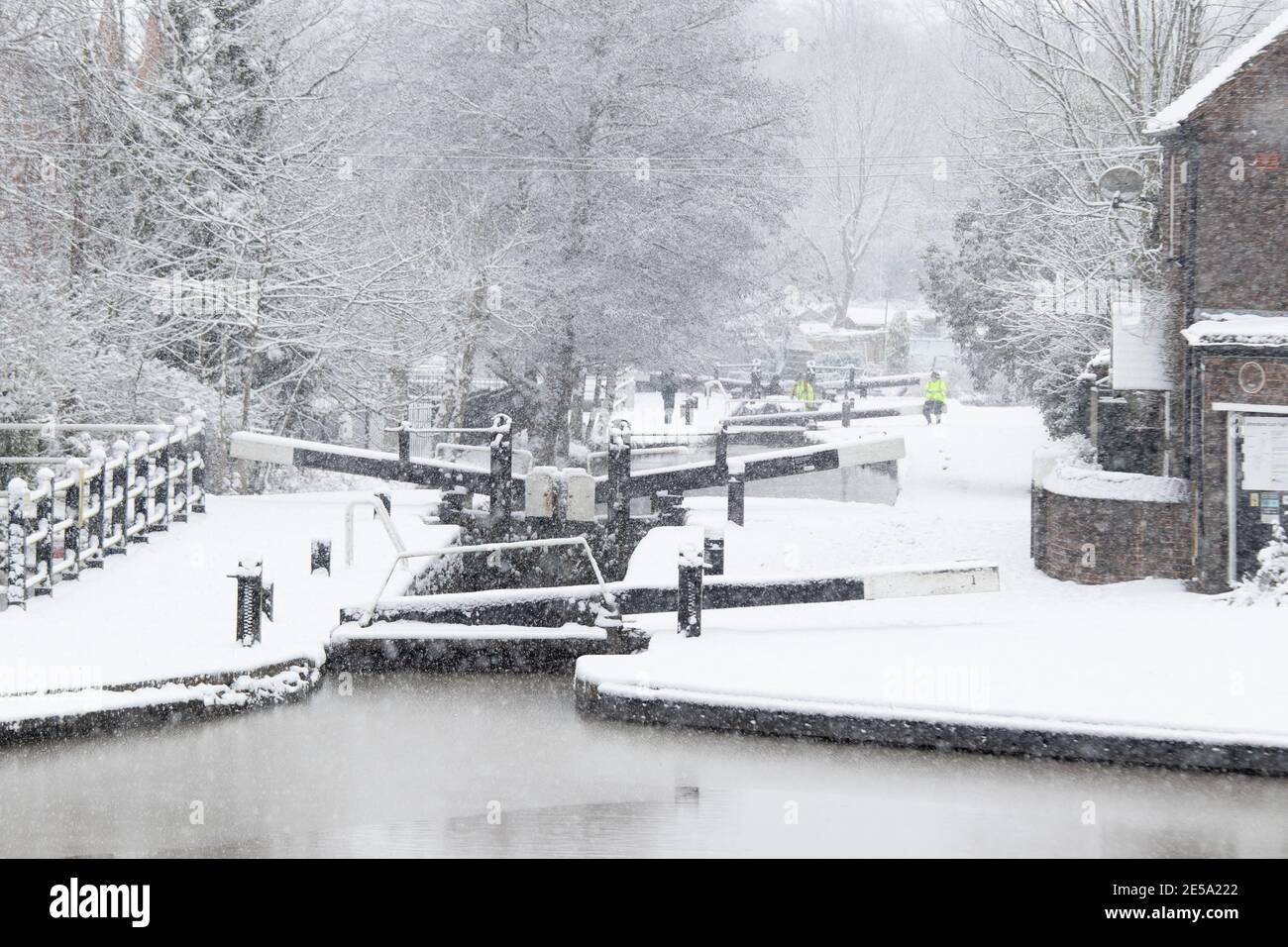 The snow covered scene along the Coventry canal near Atherstone, North Warwickshire. Pictured are the locks in the centre of Atherstone Town. Stock Photo