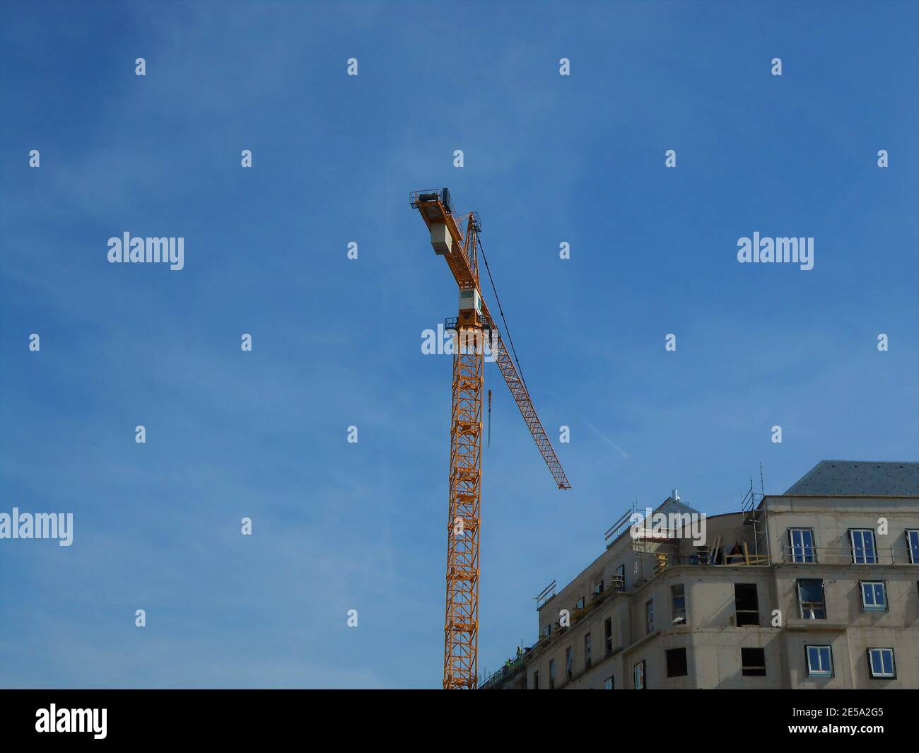 Low angle shot of a huge crane on blue sky background Stock Photo - Alamy