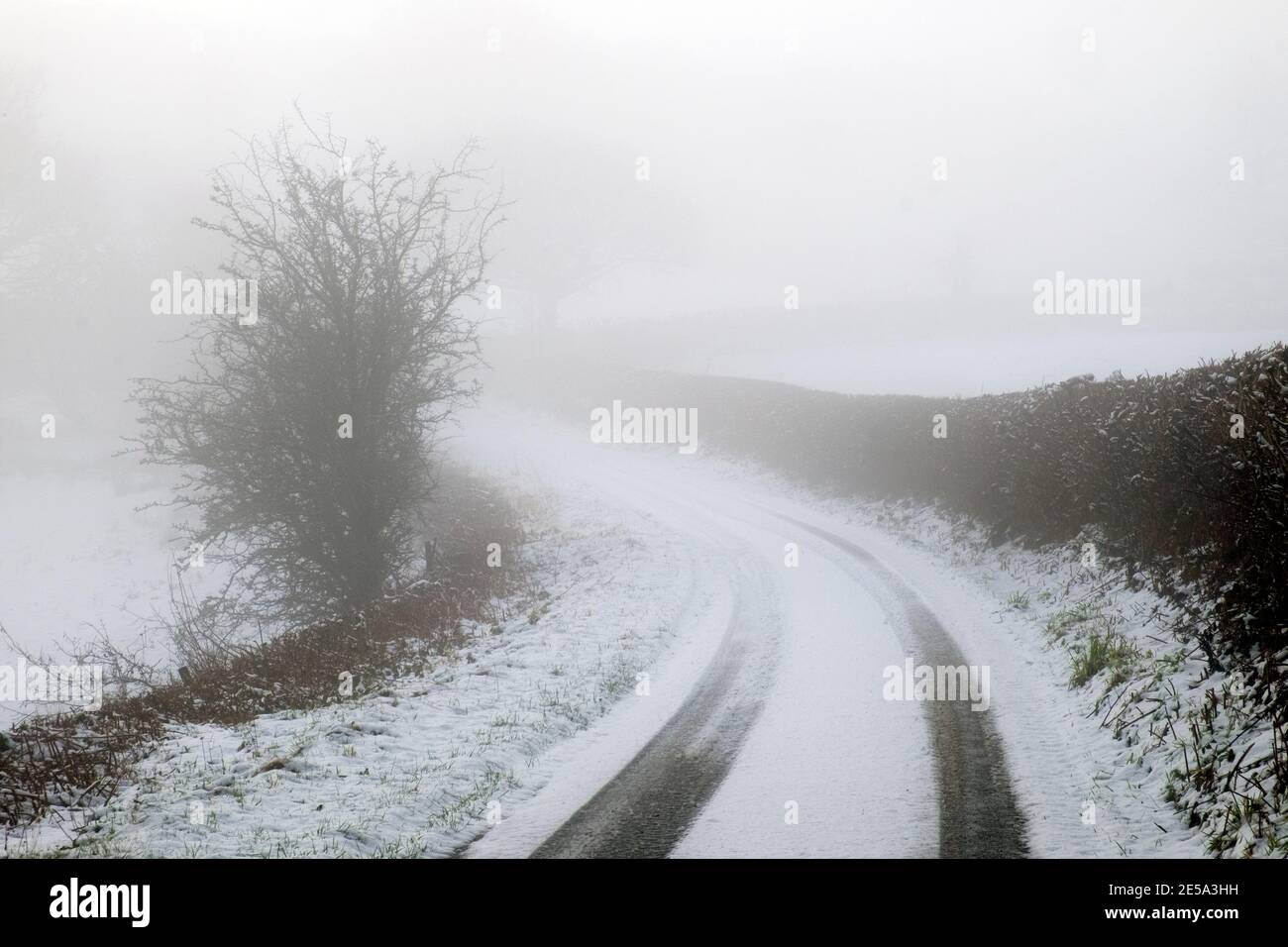 Country lane covered in ice and snow with poor visibility in winter rural Carmarthenshire Wales UK January 2021 KATHY DEWITT Stock Photo