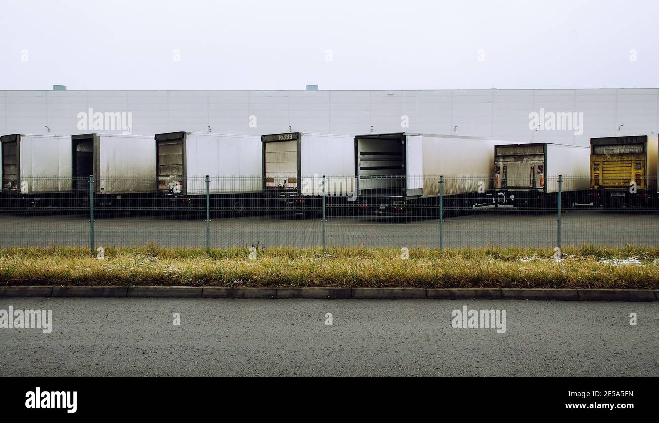 Refrigerator semi-trailers in a row parked on large distribution center Stock Photo