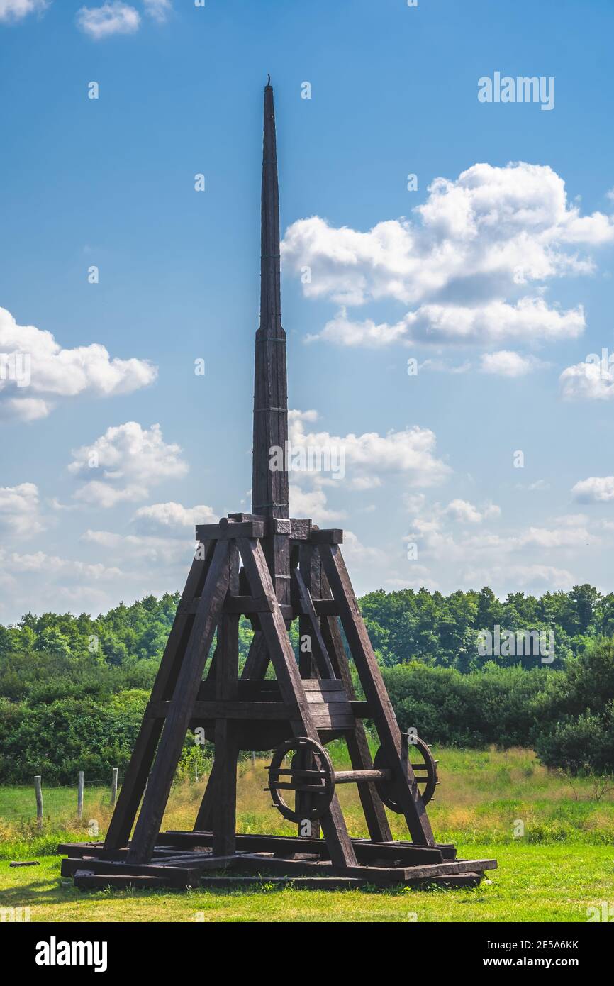Vertical shot of a medieval wooden catapult weapon in a park Stock Photo