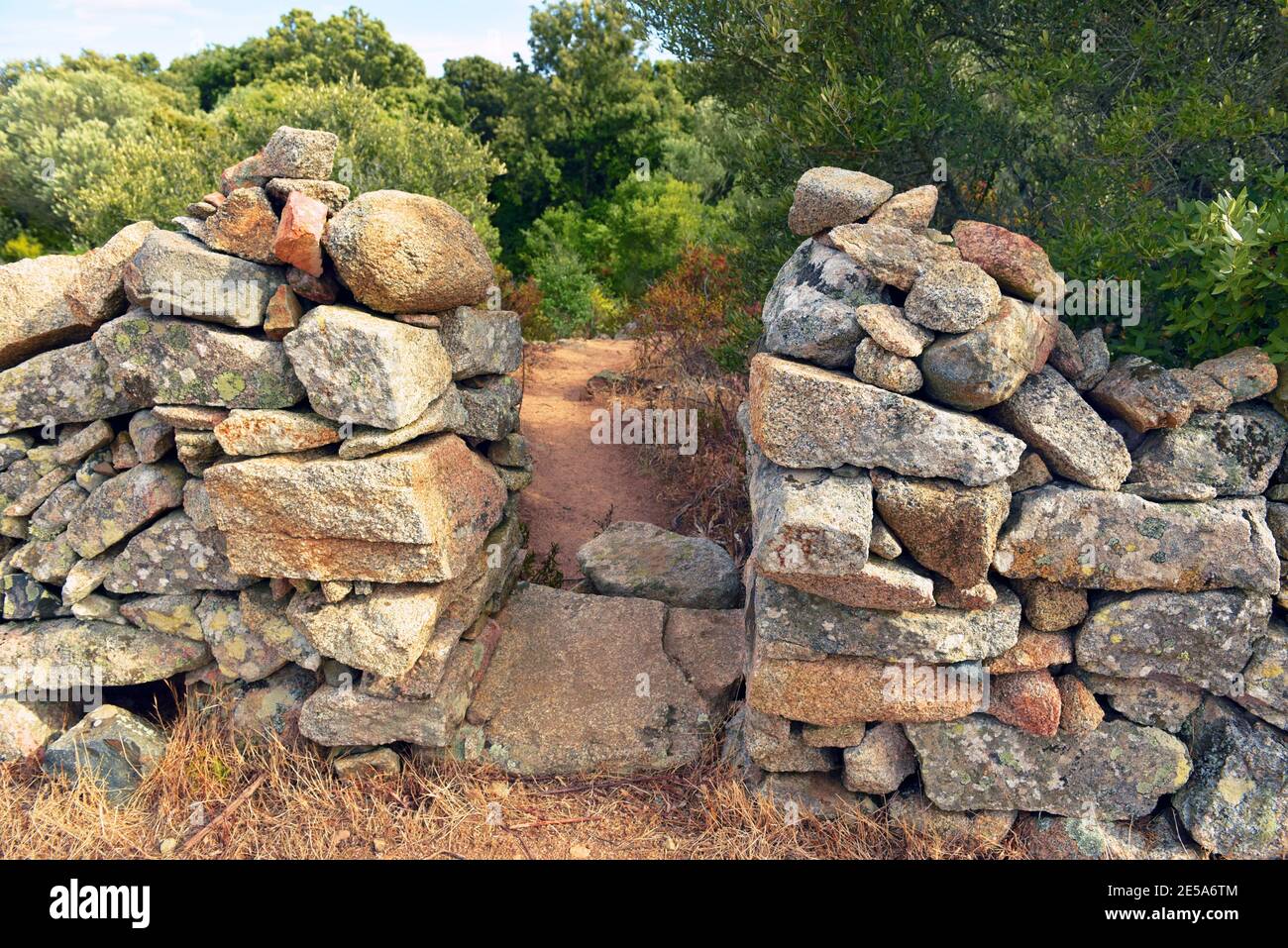 stone wall with pass to the rock formation L'Oriu de Grussettu, France, Corsica, Sartene Stock Photo