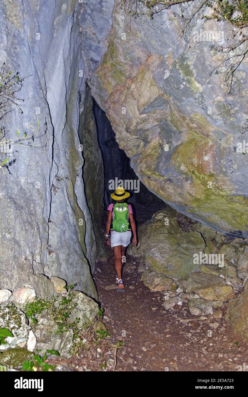 female wanderer at a cave entrance, France, Dept Var, Bauduen Stock Photo