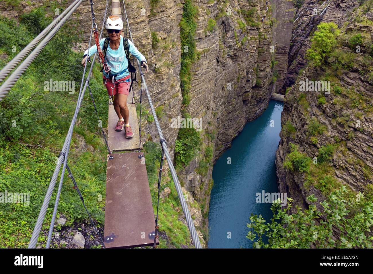 man on narrow rope bridge, via ferrata du Barrage du Sautet, France
