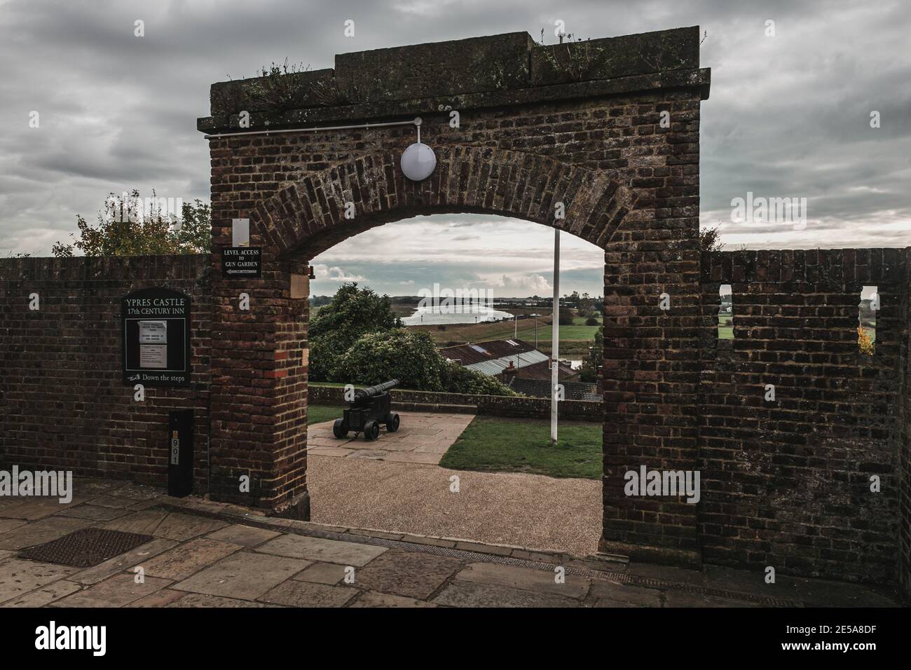 View of the gate which separates Rye Castle from its Gun Garden with a cannon on the background and the view of the River Brede, England, UK. Stock Photo