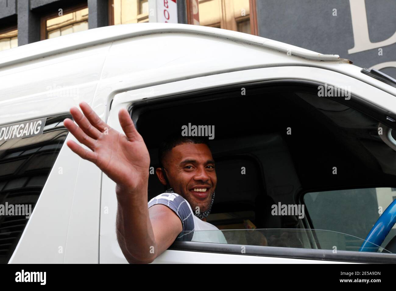 Cape Town taxi driver waving , Long Street, Cape Town, South Africa. Stock Photo