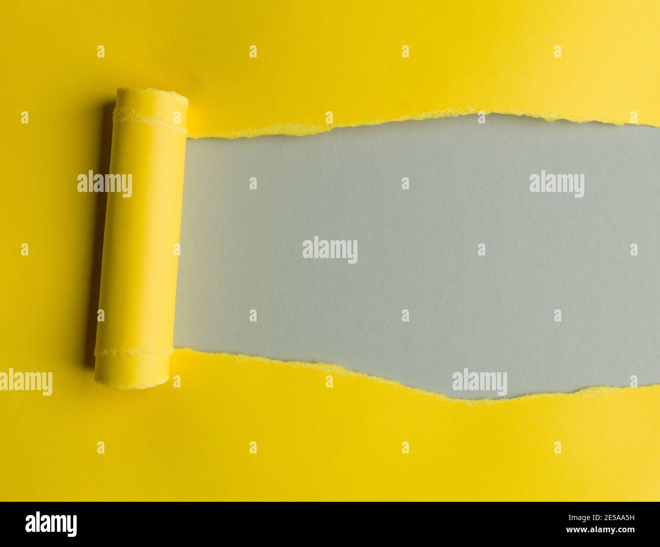 Torn yellow paper with space for text, grey background Stock Photo