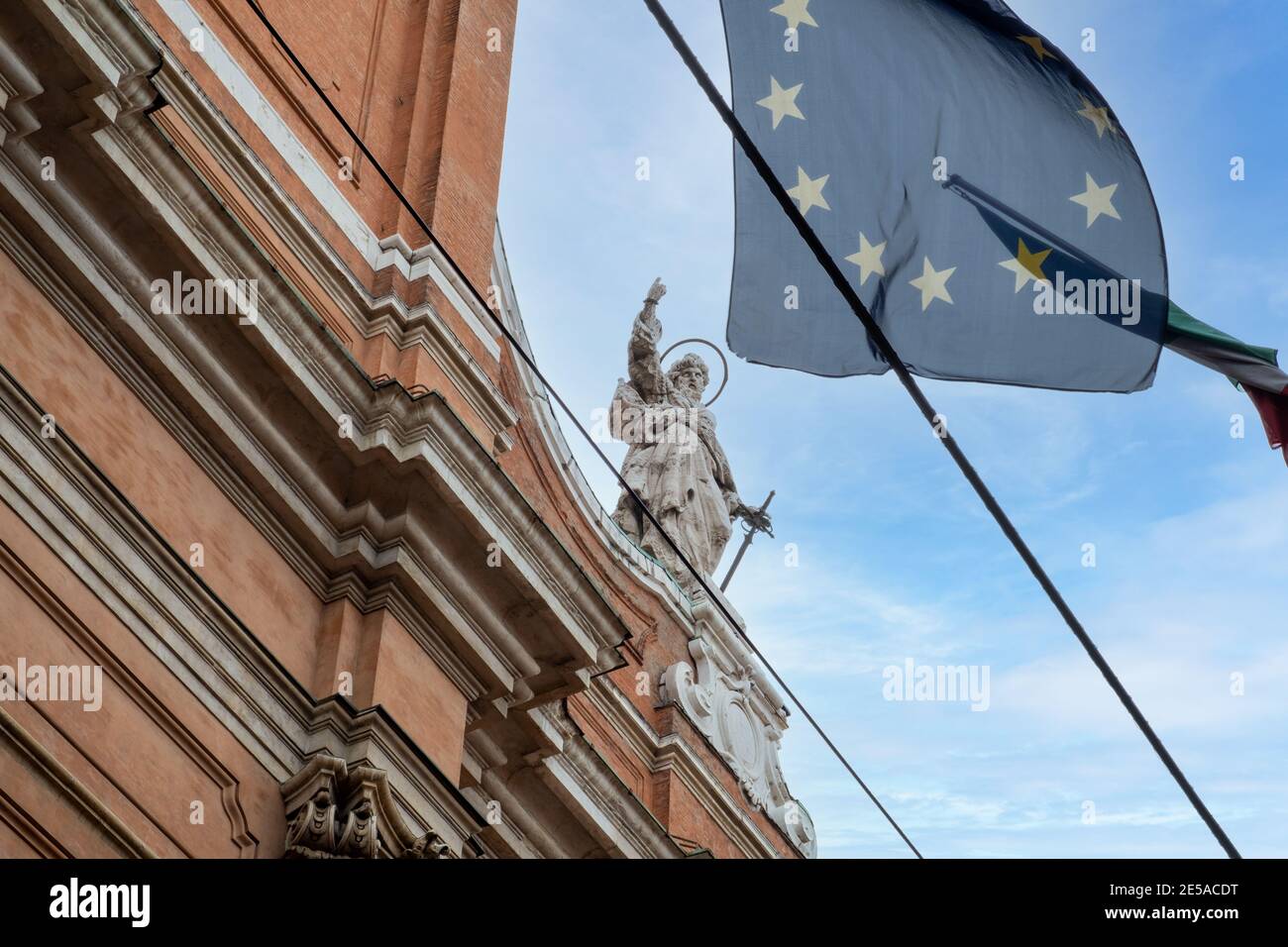 European Flag ( Flag of Europe ) blowing from statued historical building in Bologna, Italy. Stock Photo