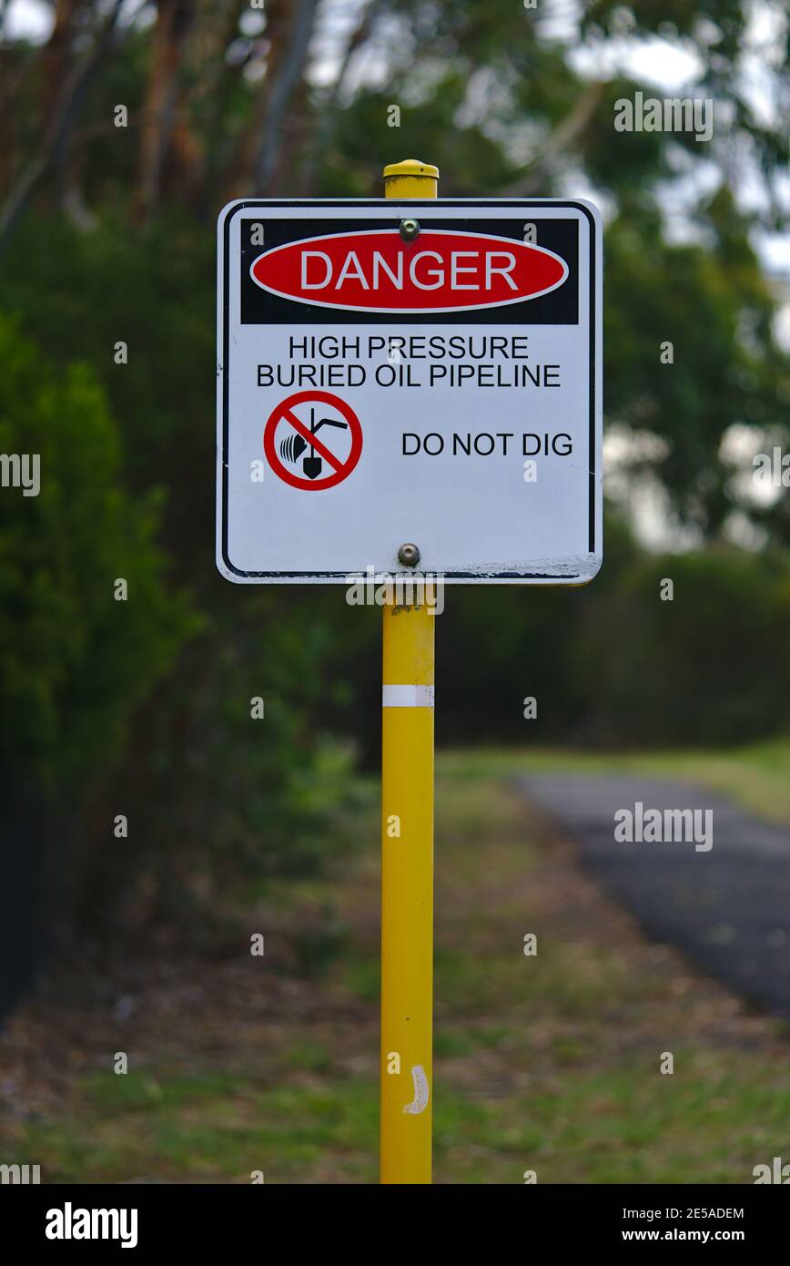 Danger high pressure buried oil pipeline do not dig sign Stock Photo