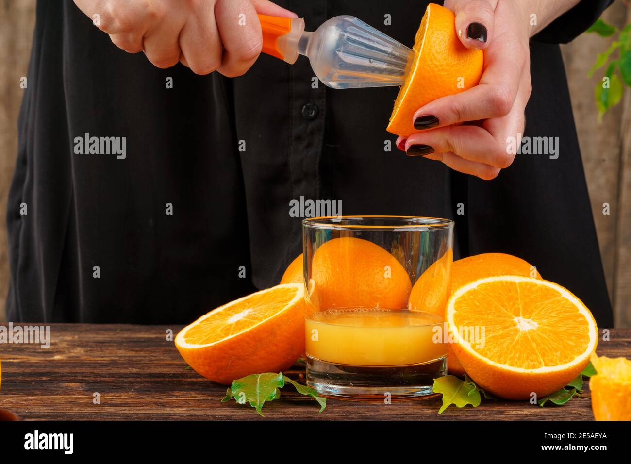 Hand squeezes half orange hi-res stock photography and images - Alamy