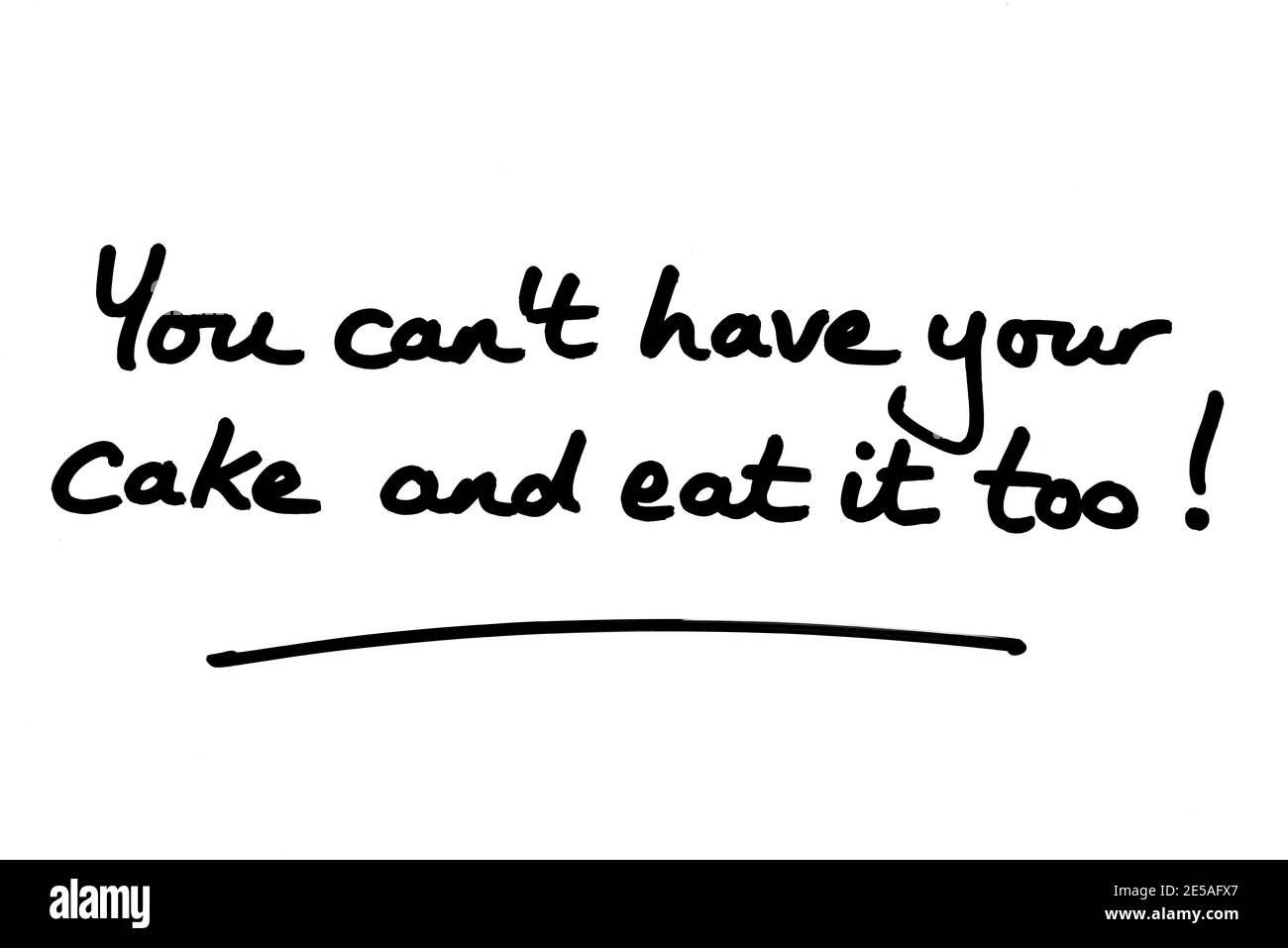 You cant have your cake and eat it too! handwritten on a white background. Stock Photo