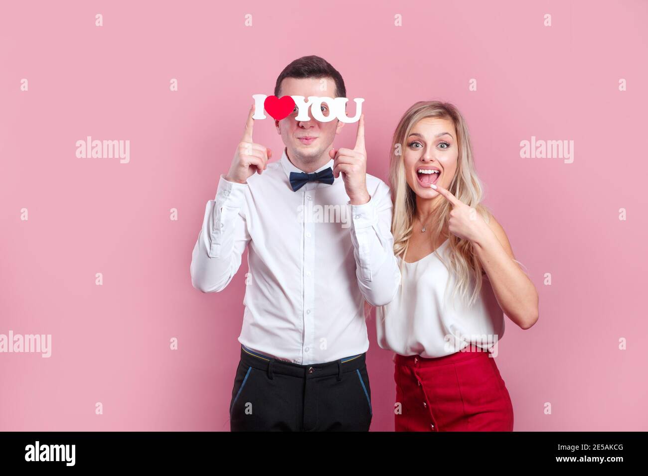 I love you. Happy couple in love on pink background. Happy Valentines day. Stock Photo