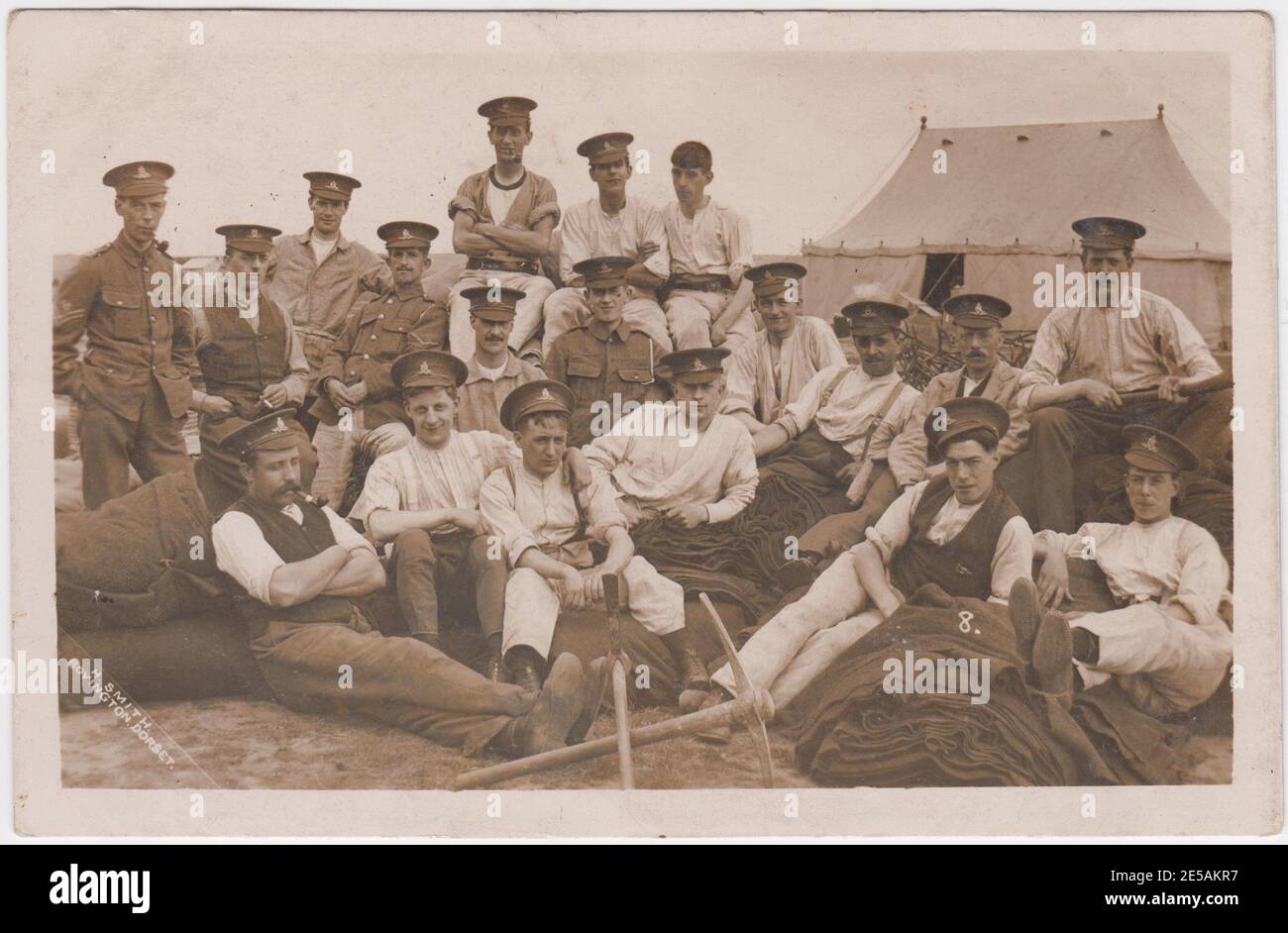 Informal group of First World War soldiers at Bovington training camp in Dorset. A pile of blankets and two pickaxes are at the front of the photograph Stock Photo