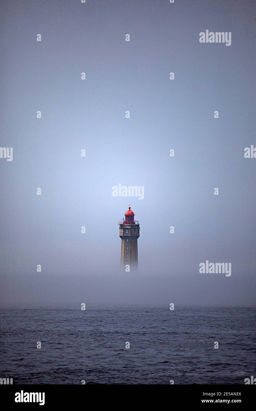 The dramatic La Jument lighthouse, shrounded in summer fog, off the coast of the Ile d'Ouessant, Brittany. The iconic 47-metre high lighthouse was bui Stock Photo