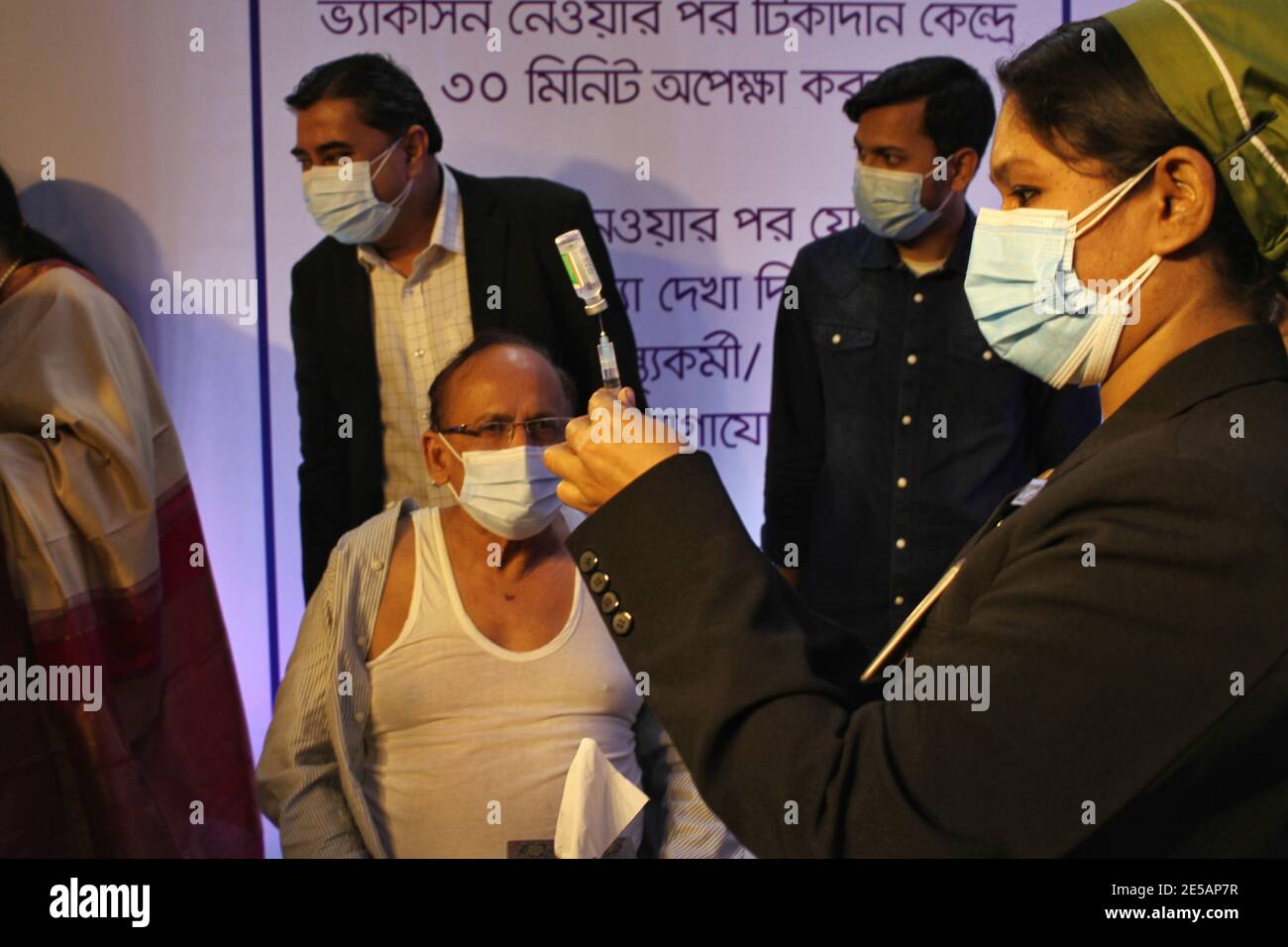 26 people receive Covid-19 vaccine in Bangladesh. Runu Veronica Costa, a senior nurse of Kurmitola General Hospital, received the first shot of the Covid-19 vaccine after Prime Minister Sheikh Hasina virtually inaugurated the pilot vaccination programme. (Photo by MD Abu Sufian Jewel/Pacific Press) Stock Photo