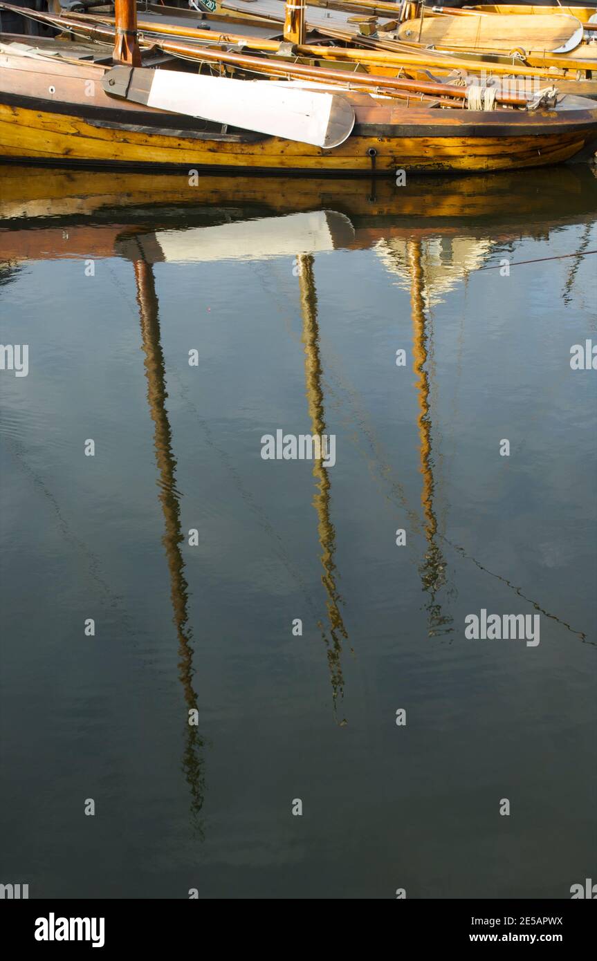 Reflection of flat bottom boats in the open air museum in the harbor of Spakenburg, the Netherlands Stock Photo