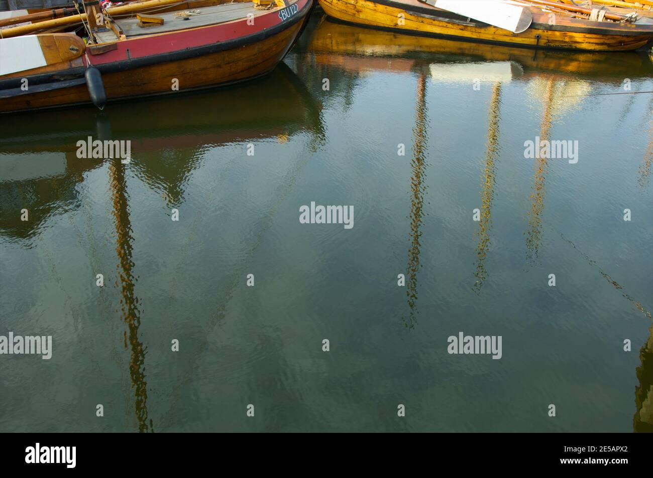 Reflection of flat bottom boats in the open air museum in the harbor of Spakenburg, the Netherlands Stock Photo