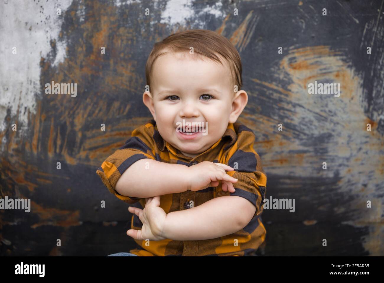 A baby boy eleven months old outdoors in the winter in a downtown setting. Stock Photo