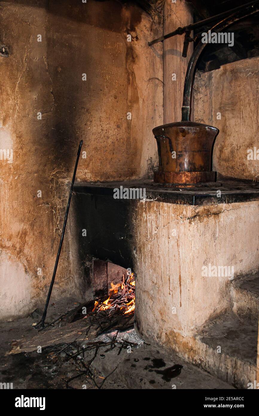 Wood fired village distillery producing local fruit brandy called rakia, Bulgaria Stock Photo