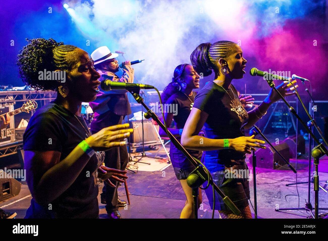 Jazzie B on stage with backing singers  during Soul II Soul live performance in Cardiff Stock Photo