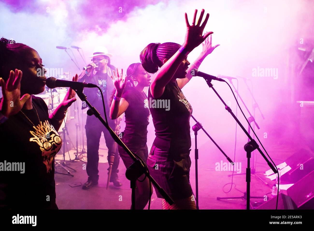 Jazzie B on stage with backing singers  during Soul II Soul live performance in Cardiff Stock Photo