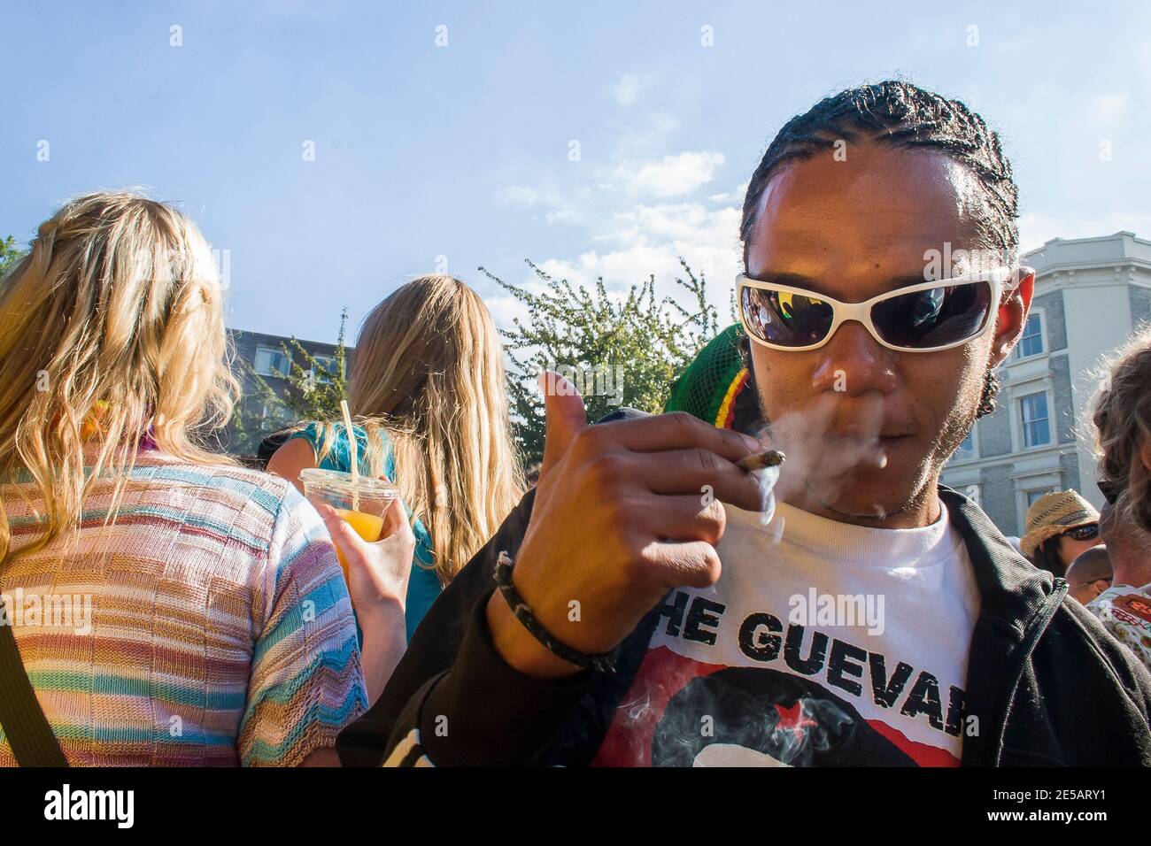 Young boy smoking in the crowd at Notting Hill Carnival Stock Photo