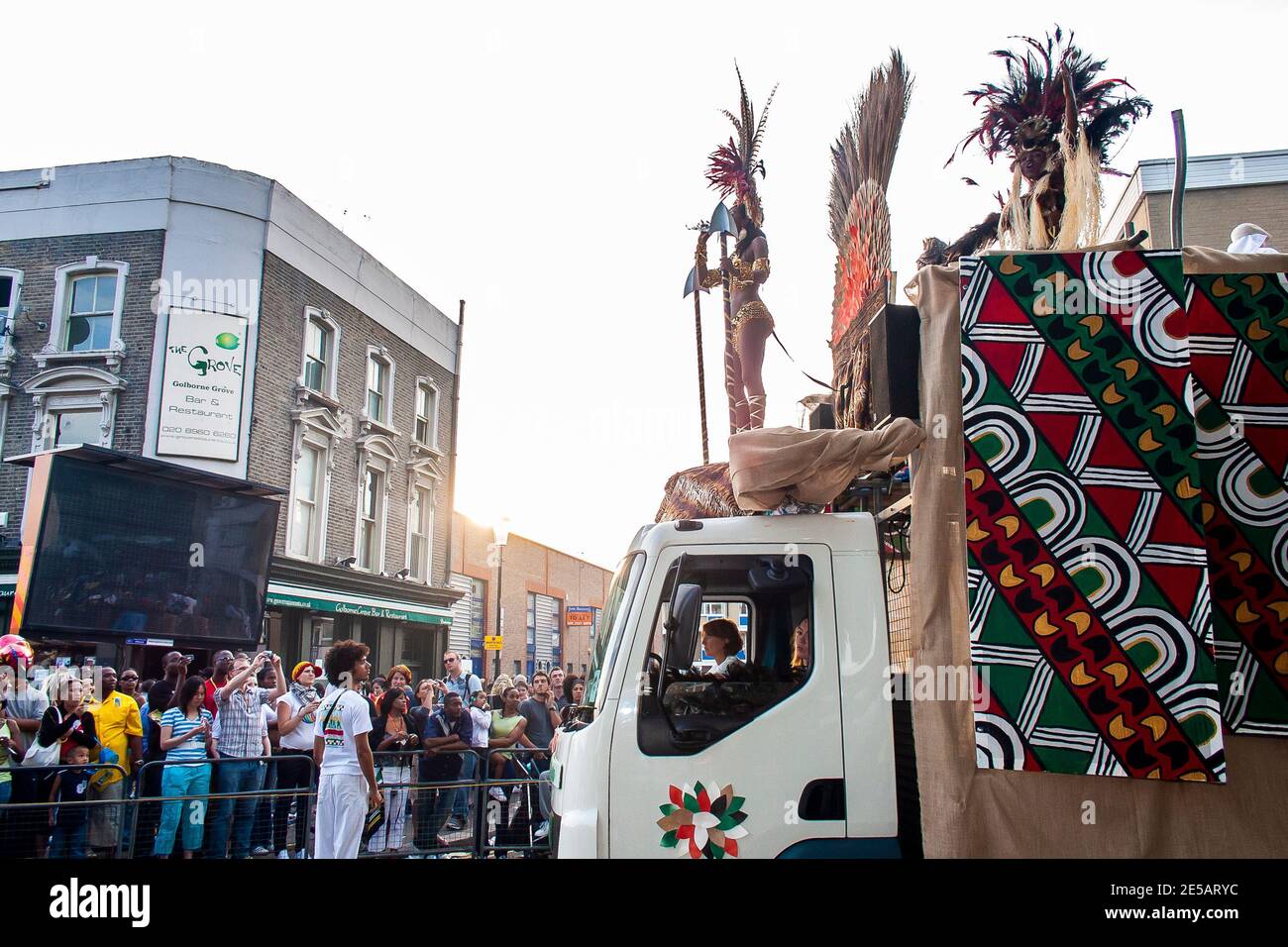 Huge carnival float with dancers in costumes moves through the streets at Notting Hill Carnival Stock Photo