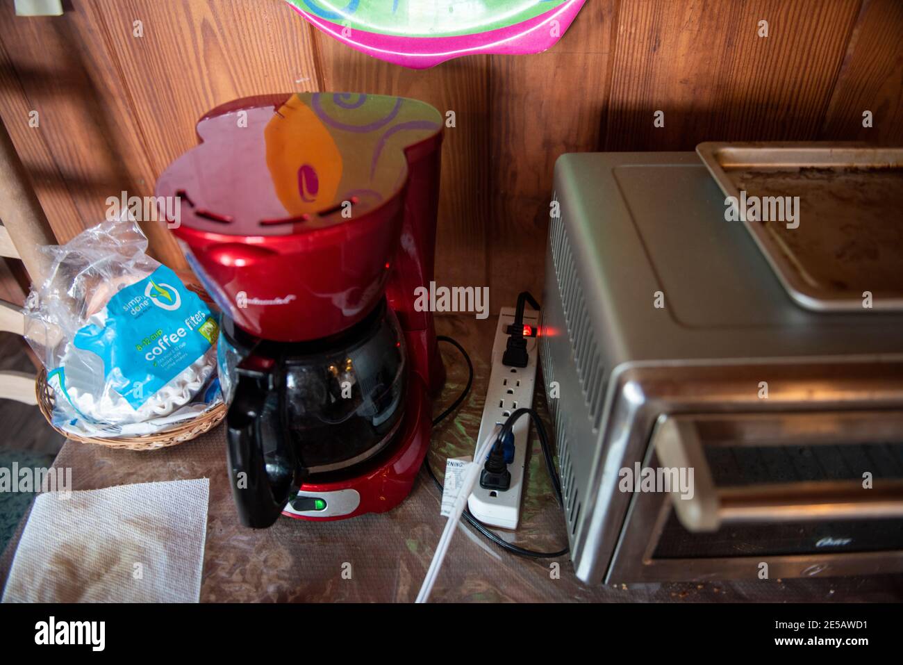 A surge protector with many appliances plugged in. Stock Photo