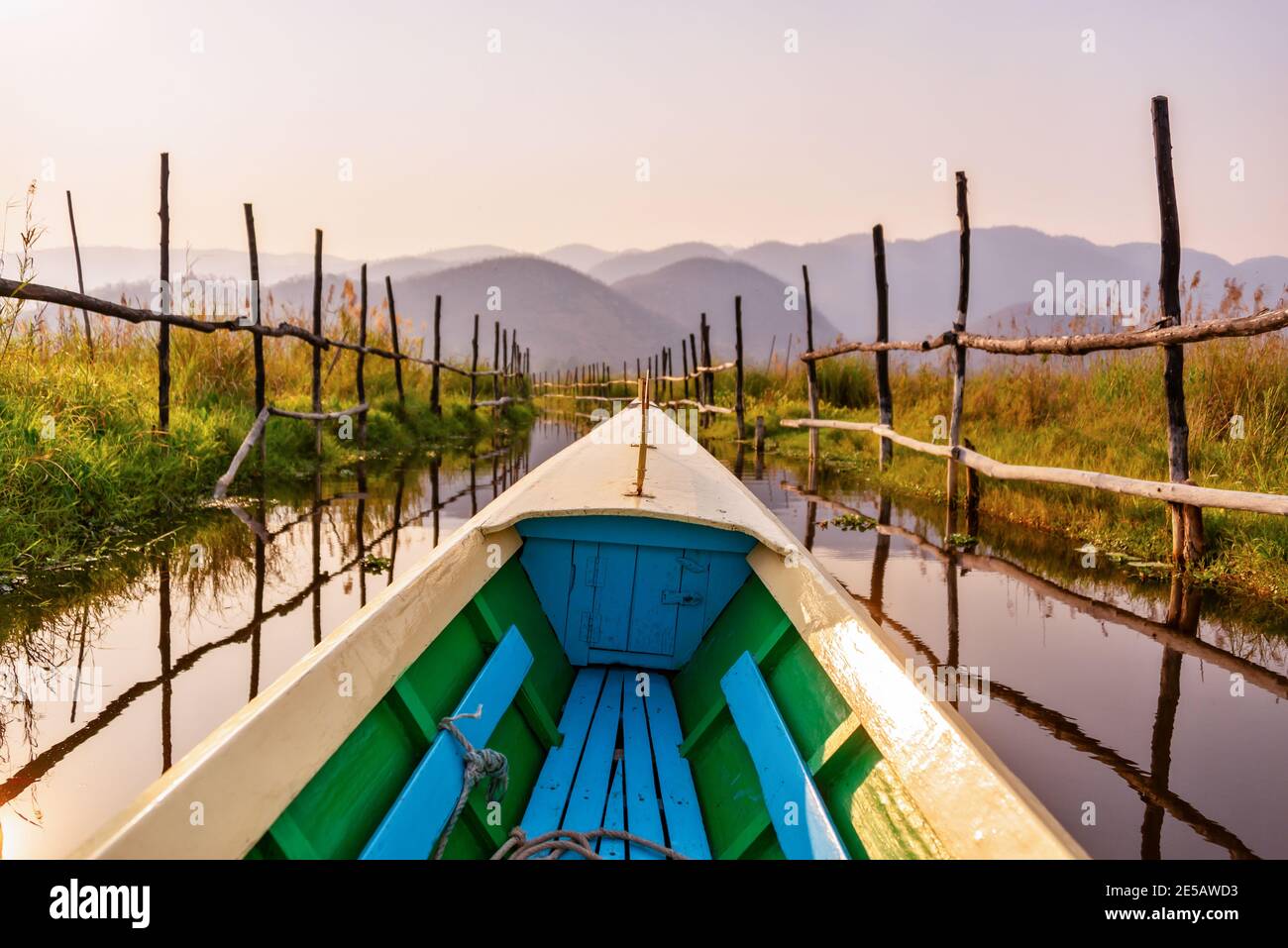 Boat tour in the floating gardens of Inle lake at sunset in Burma
