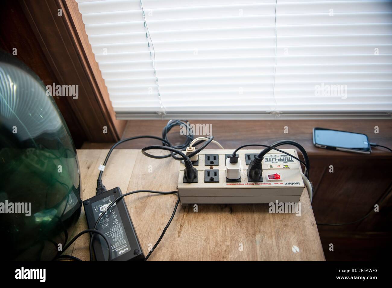 A surge protector with many cords plugged in. Stock Photo