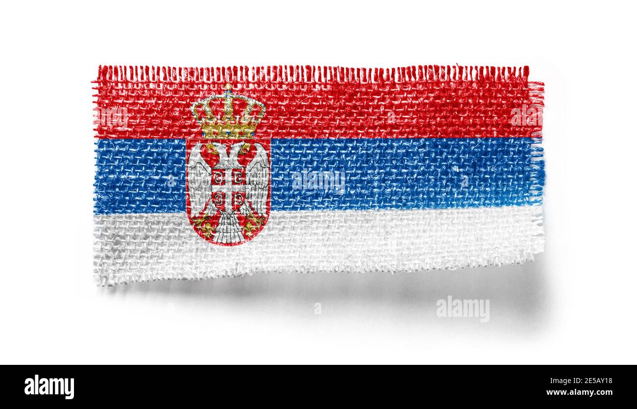 Serbia flag on a piece of cloth on a white background Stock Photo