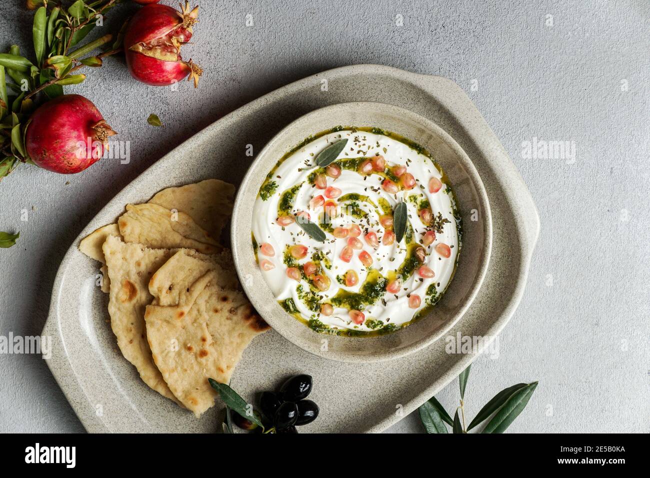 iranian or arabian dish, yogurt labneh goats milk dip with taftan bread