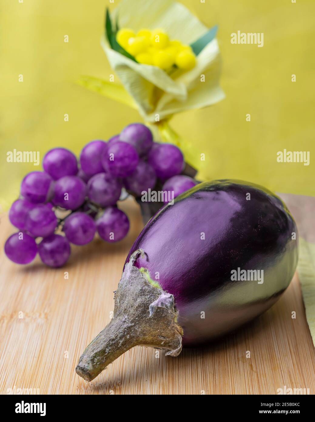 Composition of yellow and purple colors, with aubergine, grapes and