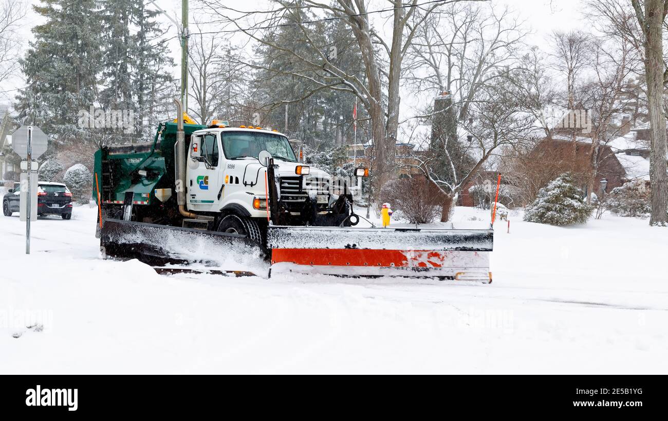 Snow plow truck in motion clearing a municipal road, street, after