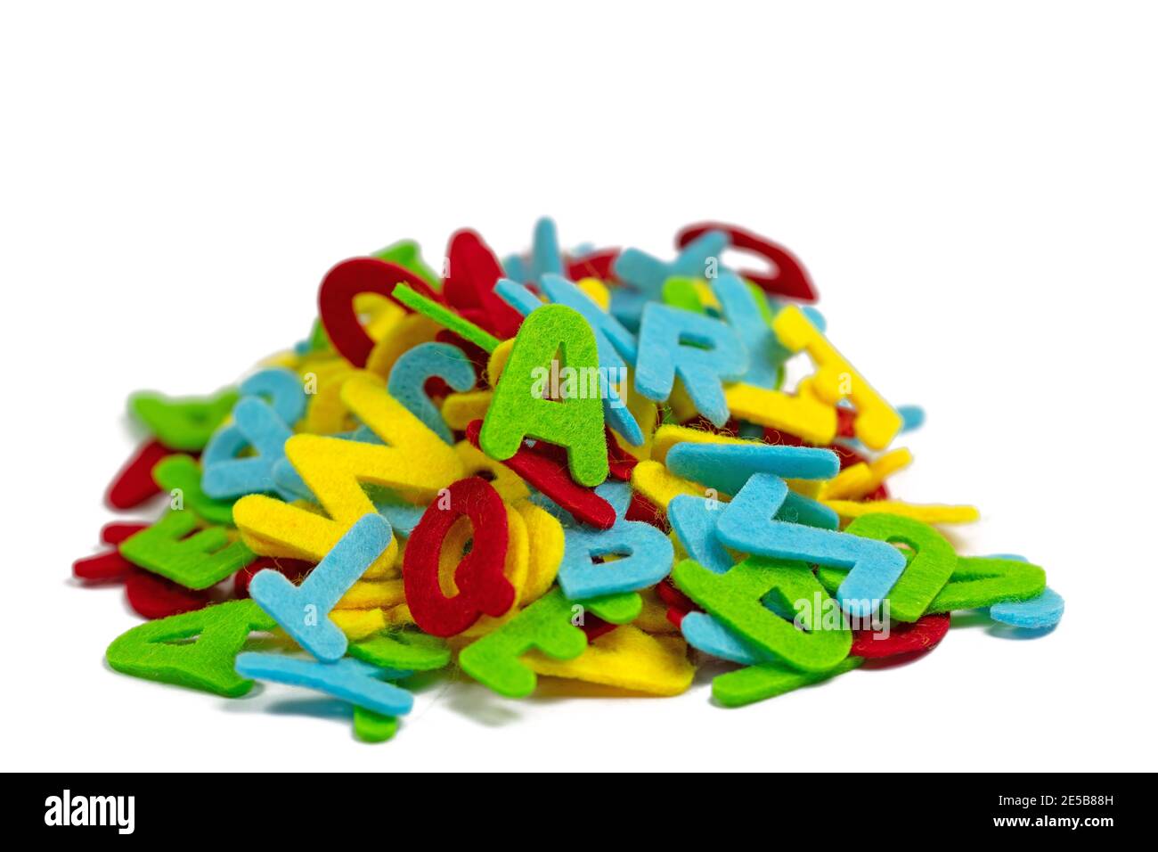 Lots of colorful felt letters against a white background Stock Photo