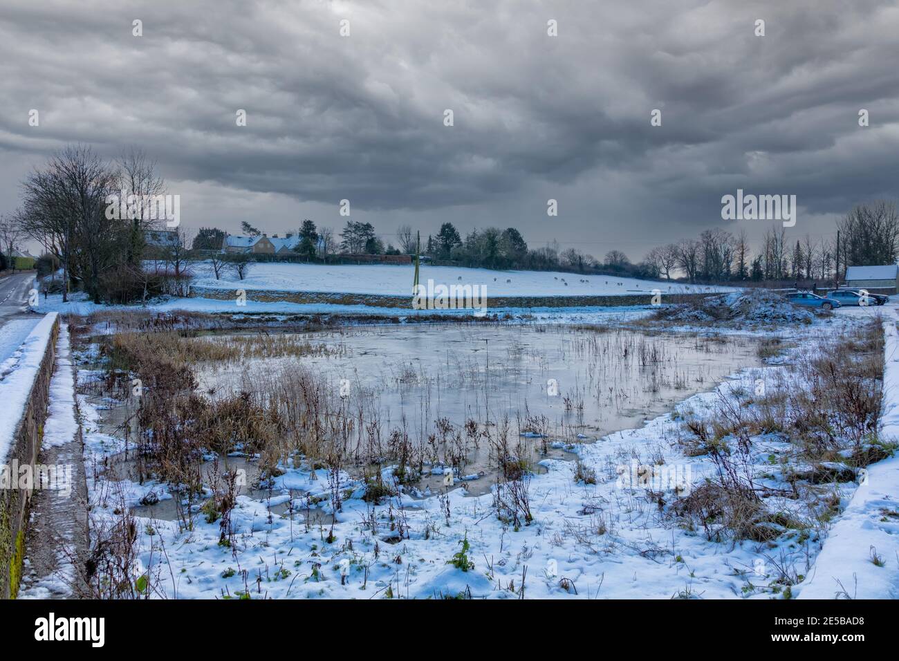 Frozen village pond in winter of 2021, Hawkesbury Upton, The Cotswolds