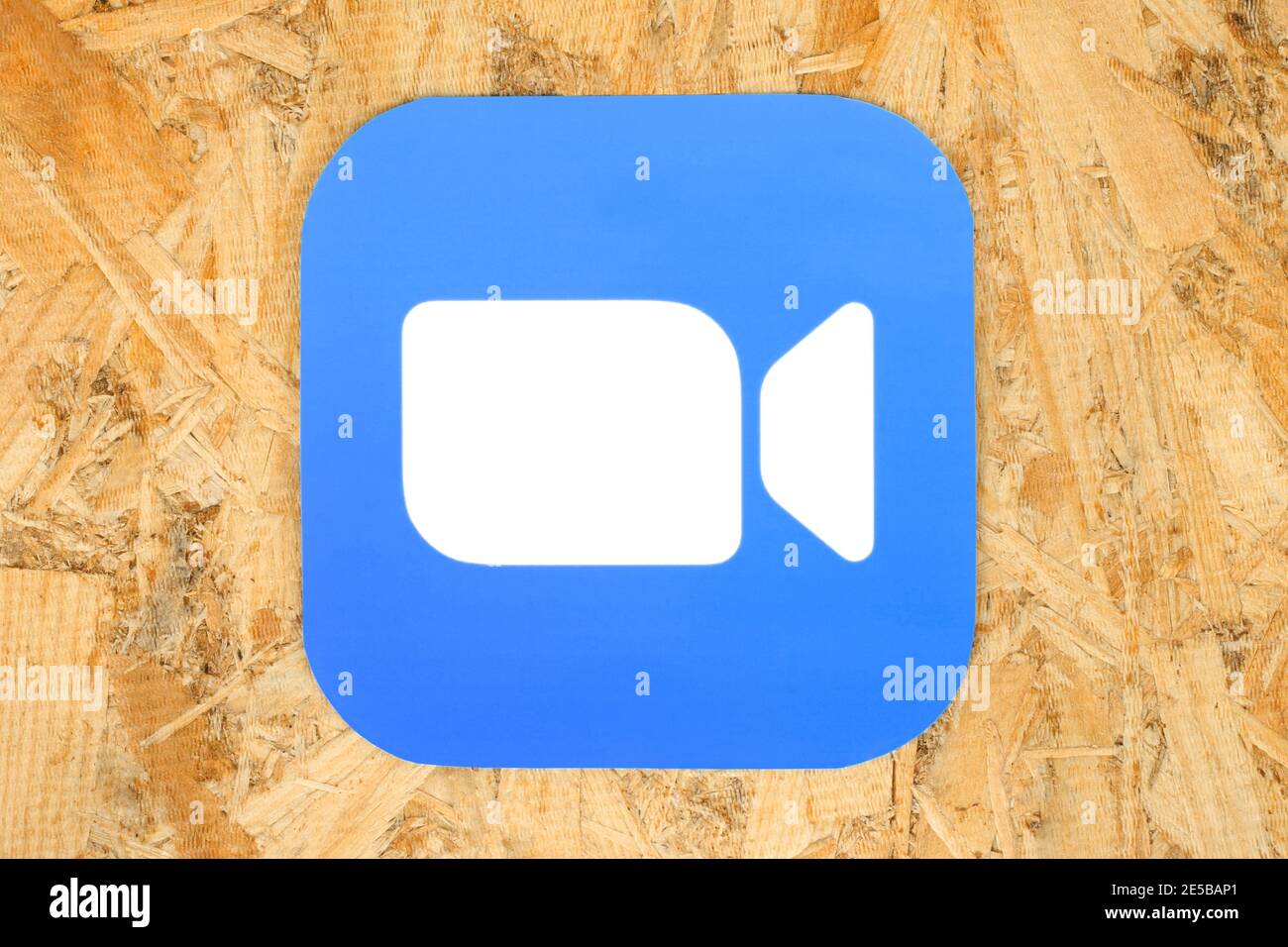 Kiev, Ukraine - August 25, 2020: Zoom icon on wooden background close-up, printed on paper. Zoom is a videotelephony software program developed by Zoo Stock Photo