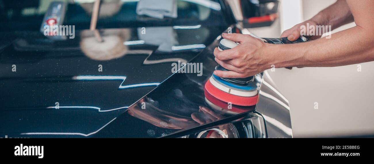 Process of car detailing by hand polisher, polishing the car in the studio, car care concept Stock Photo