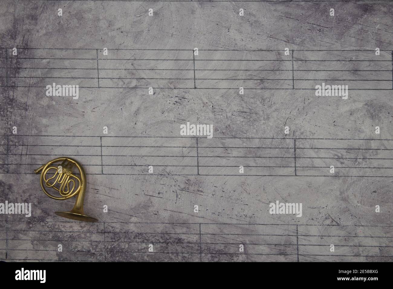 Music sheet background with a miniature wind instrument Stock Photo